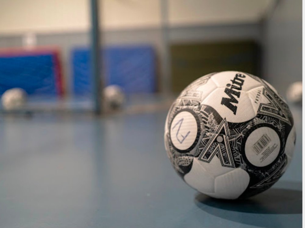 A futsal player shooting at goal during an indoor match in Brunswick