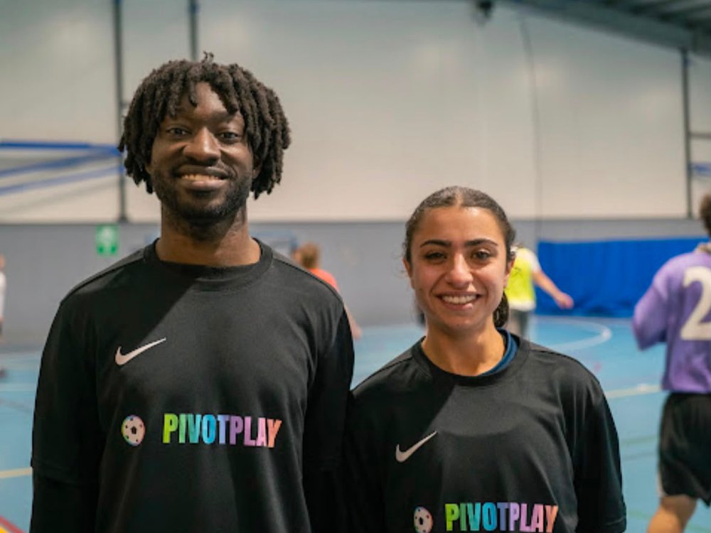 Two Pivot Play players in branded shirts at a Brunswick futsal game
